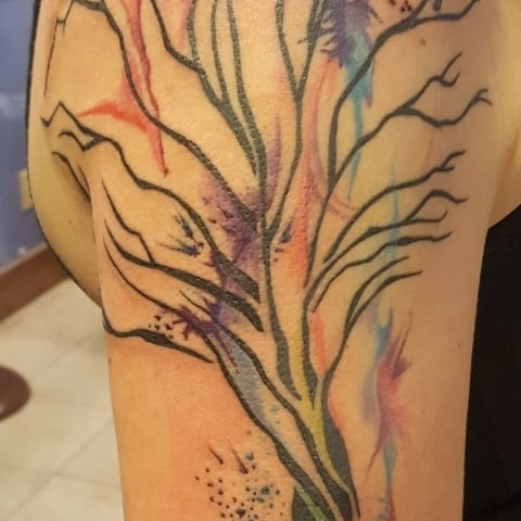 Tattoo of a colorful and stylistic tree