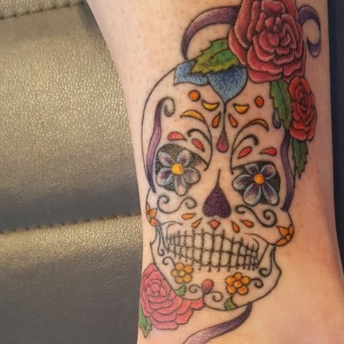 Tattoo of a calavera skull with flowers