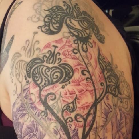Tattoo of a detailed abstract flower bouquet