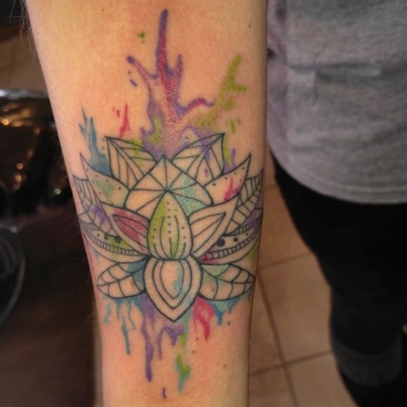 Tattoo of a patterned lotus with colorful splashes