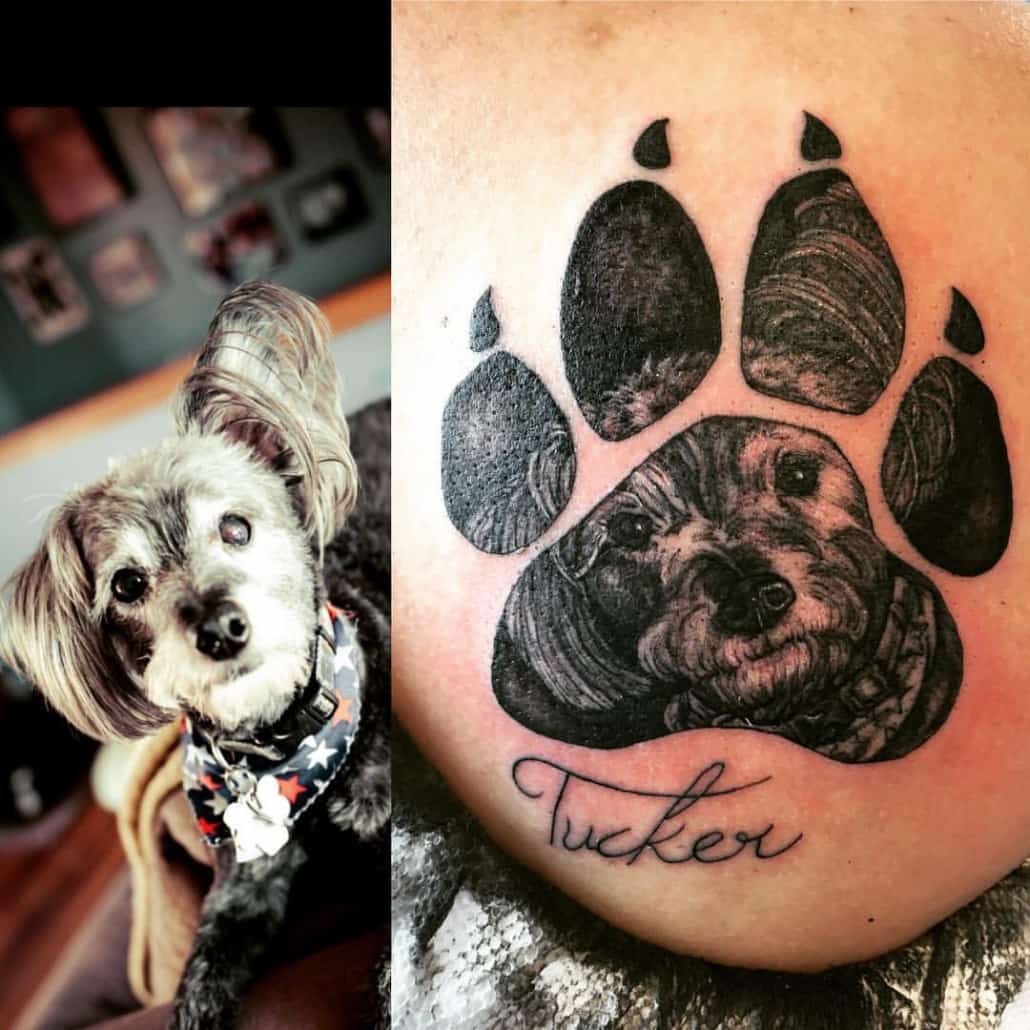 Tattoo of a detailed dog in a paw print