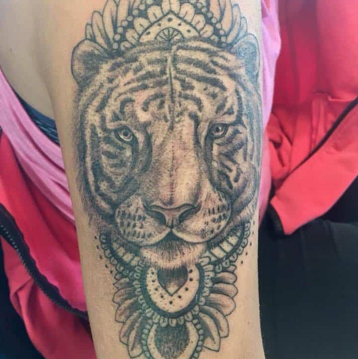 Tattoo of a tiger with a pattern around it