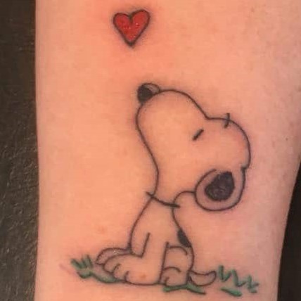 Tattoo of Snoopy the dog looking at a heart
