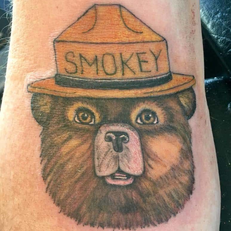 Tattoo of a detailed Smokey the Bear