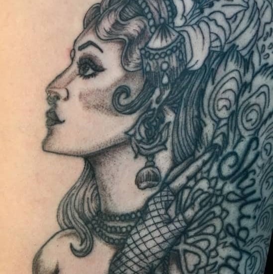 Tattoo of a detailed woman with flowers in her hair