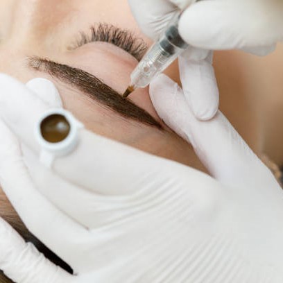 permanent eyebrow color being applied