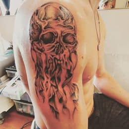Tattoo of a detailed decaying skull