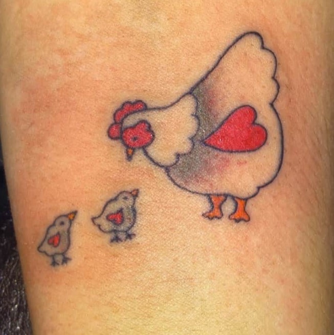 Tattoo of a hen with her chicks